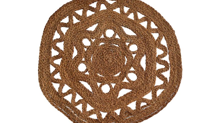 Woven jute placemat with circular patterns and triangular cutouts.