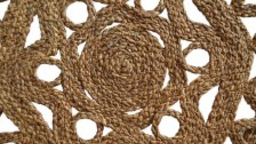 Woven jute pattern with circular design and cutout shapes.