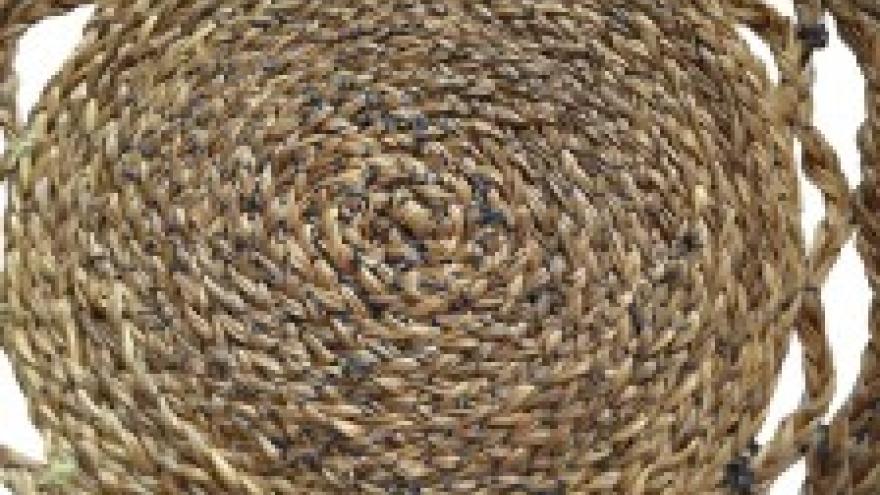 Woven straw mat in a circular pattern.