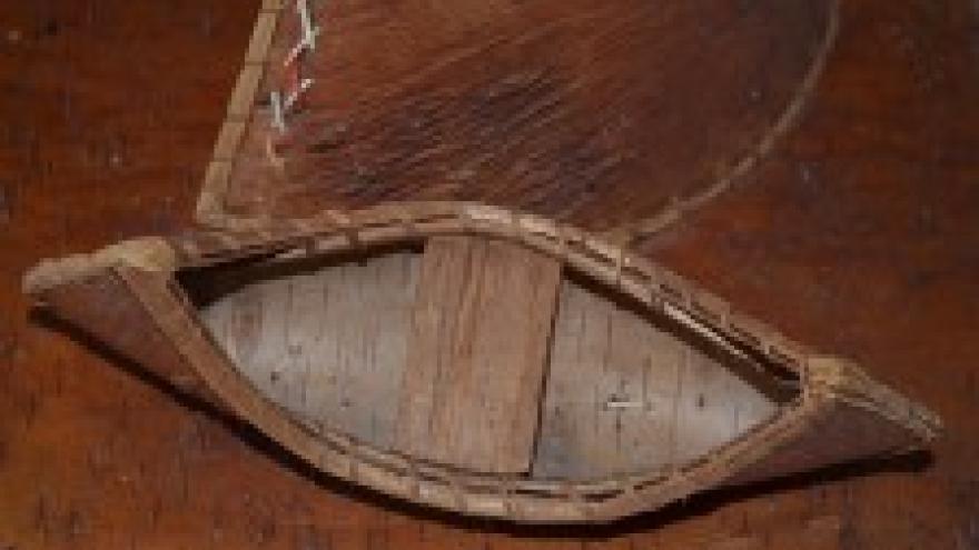 Traditional leather teepee and canoes.
