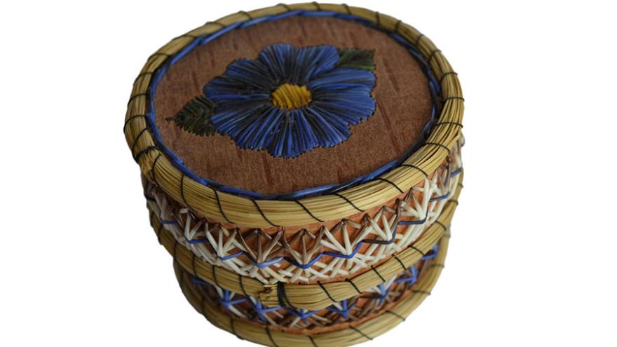Basket with woven pattern, blue flower on lid.
