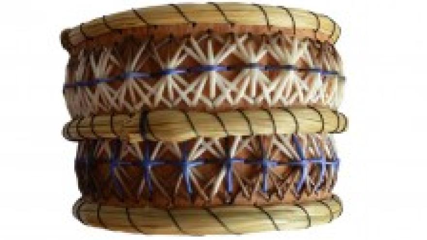 Woven basket with intricate blue and white patterns.