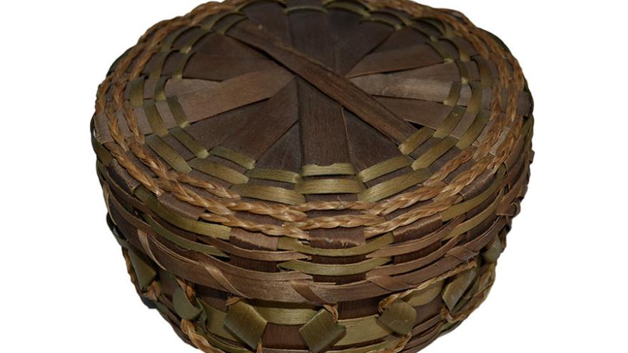Woven basket with a round lid, brown and green bands.