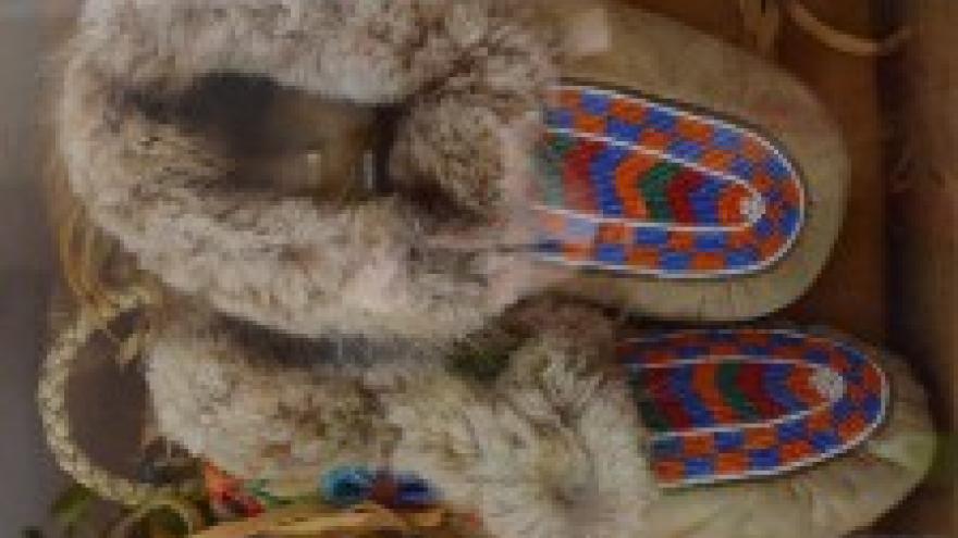Fur-lined moccasins with colorful beaded patterns.