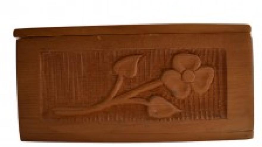 Carved wooden box with a flower design.