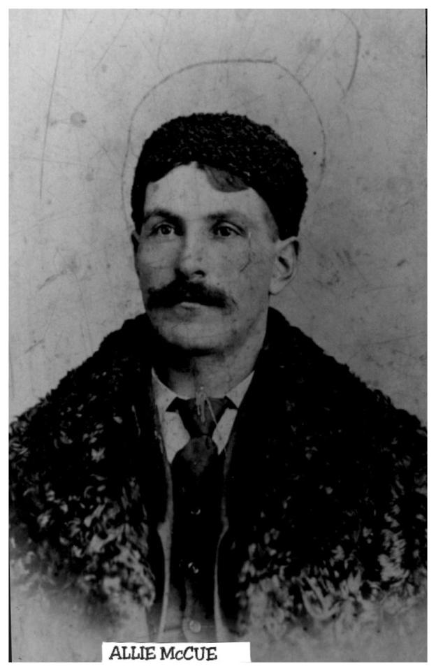 Black and white photo of a man with a mustache wearing a fur coat.
