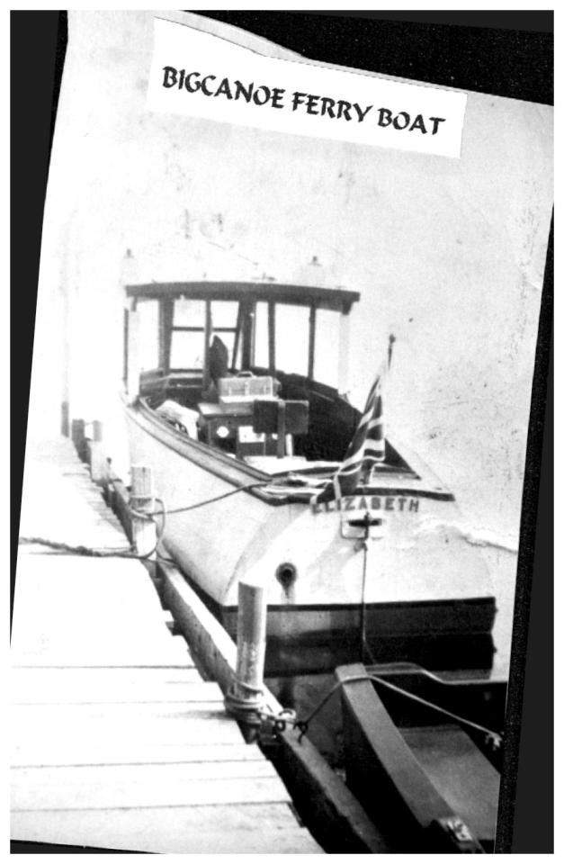 Black and white photo of a ferry boat docked at a pier.
