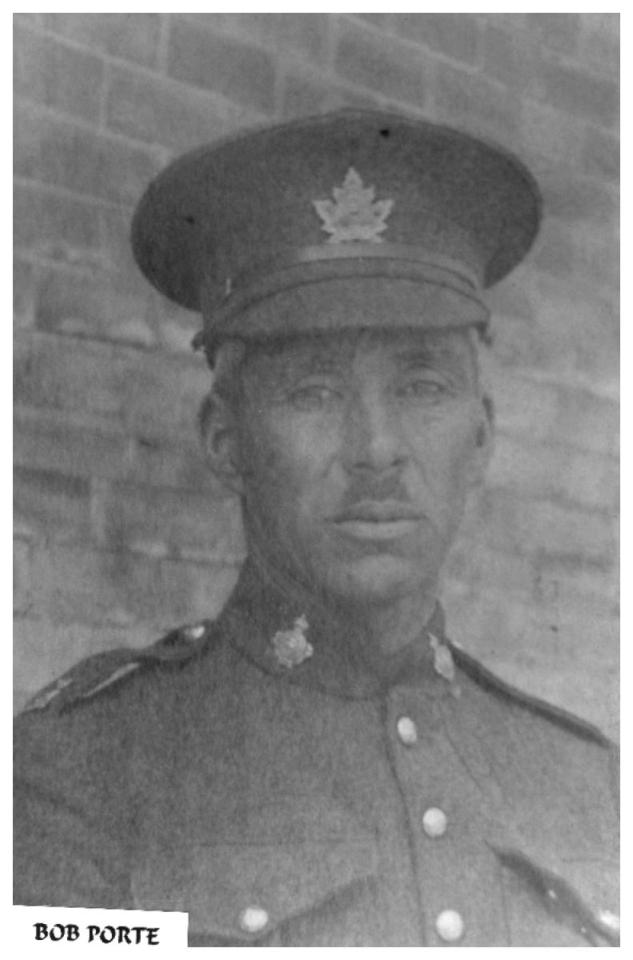 Black and white photo of a soldier in uniform with a cap.