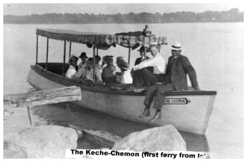 Boat with passengers wearing hats, docked by the shore.