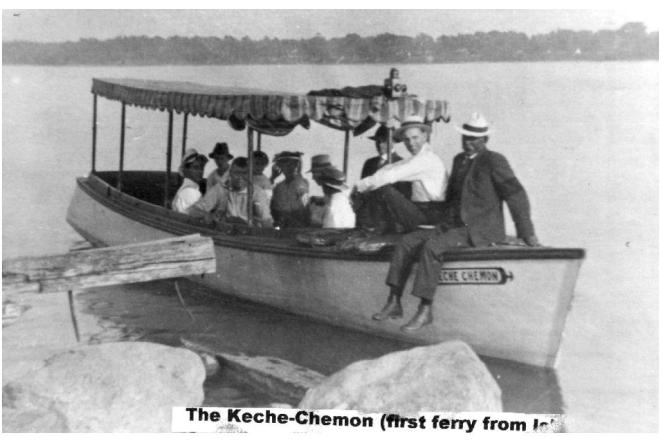 Boat with passengers wearing hats, docked by the shore.