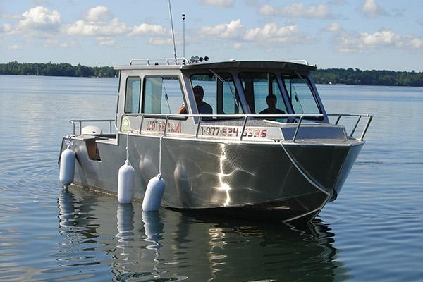 Small metallic water taxi boat on a calm lake.